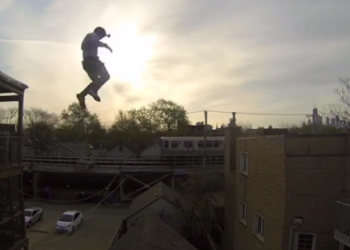 First-Person-GoPro-Video-of-a-Stuntman-Jumping-Onto-and-Sliding-Down-a-Steep-Gable-Roof-in-Chicago.png