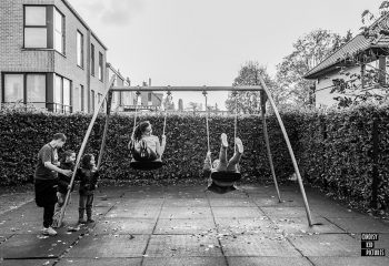 Happy kids swinging on playground
