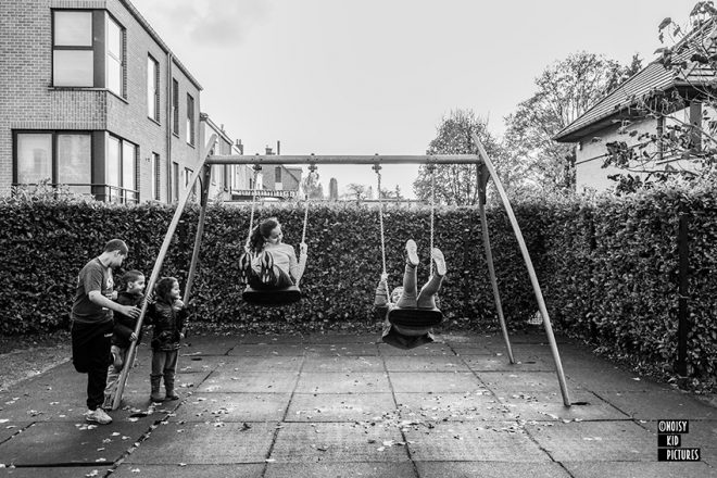 Happy kids swinging on playground